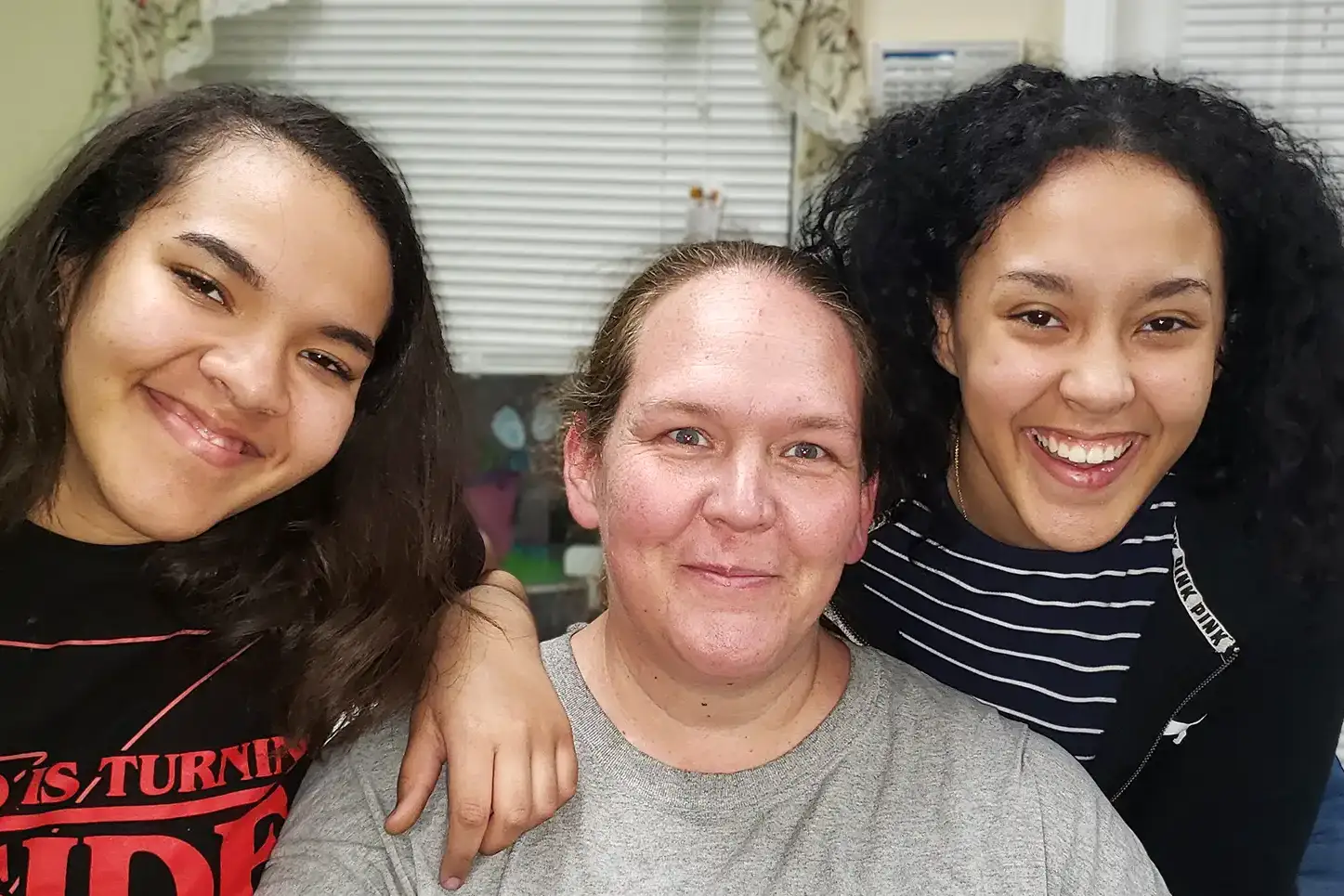 Mother and her two daughters in the comunity center at a Phoenix Family community event
