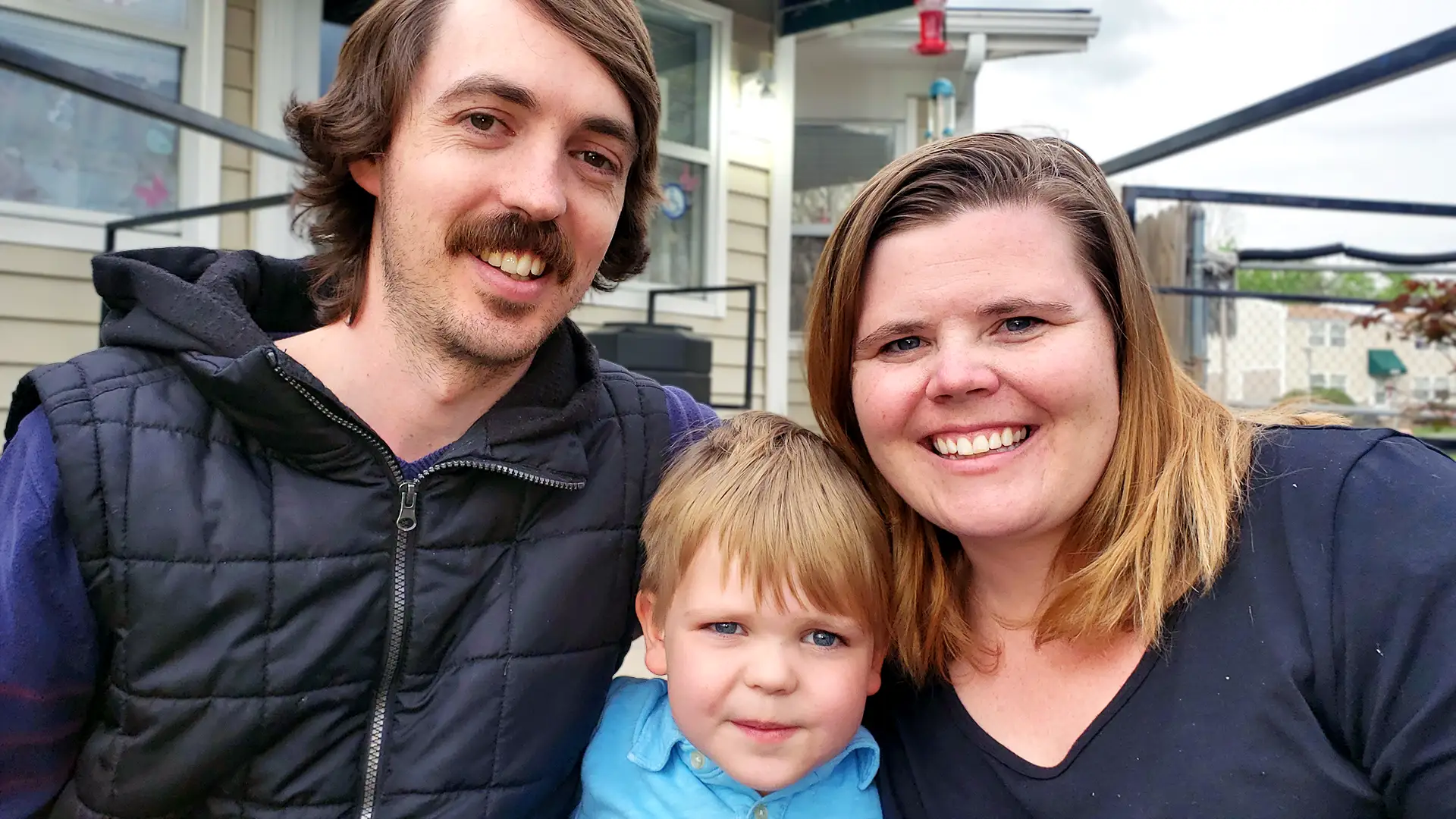 A parent and child outside their home in a Phoenix Family community