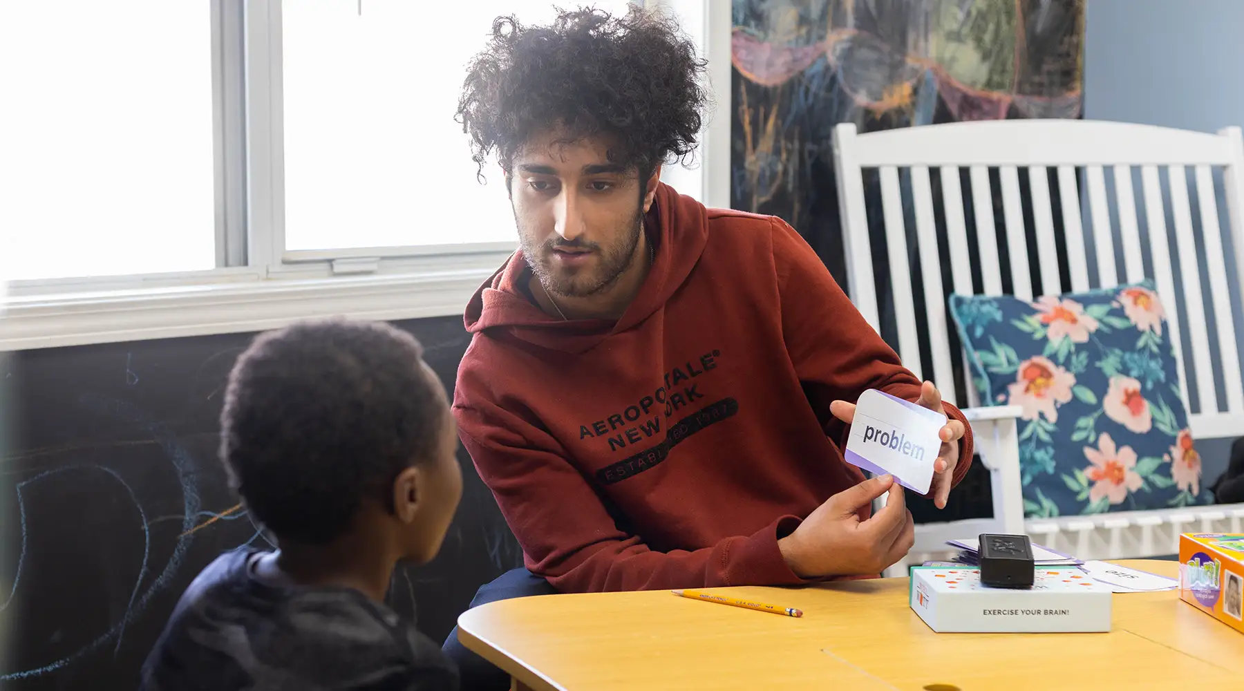 A child working one-on-one with a reading coach during a Phoenix Family HIKE session