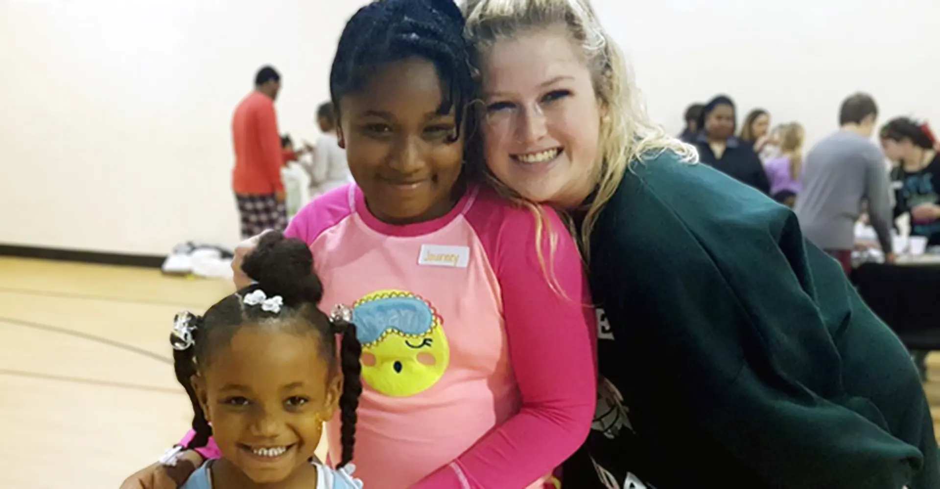 Volunteer helping at a Phoenix Family children's holiday event.
