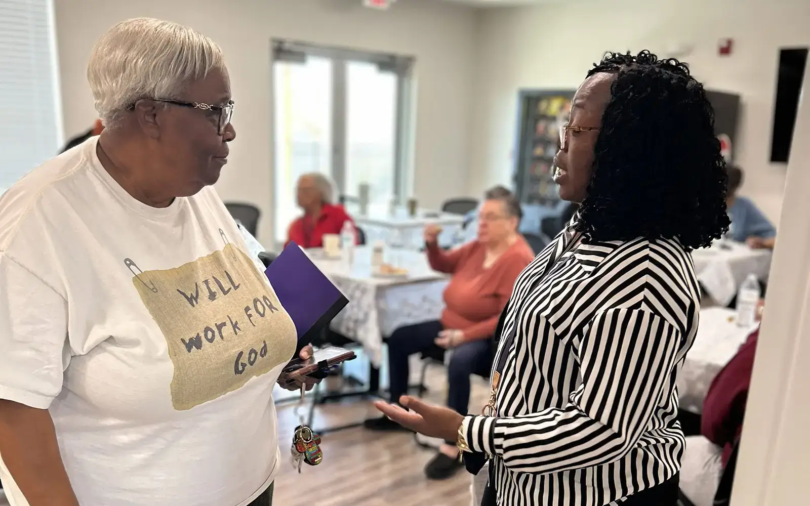A resident meeting with a Phoenix Family staff member in her community