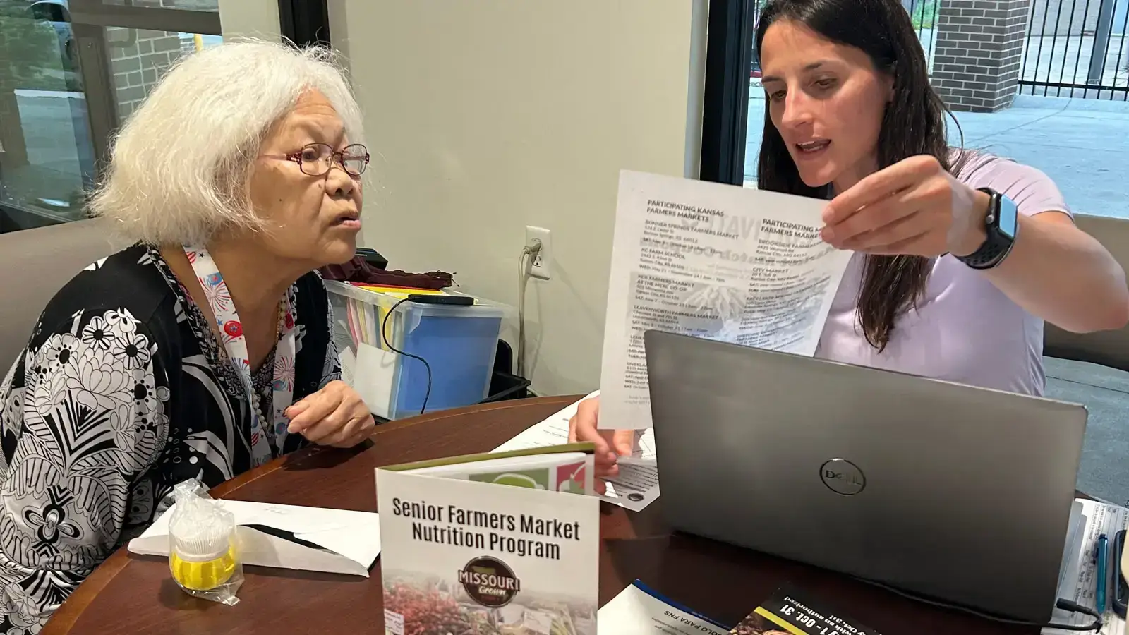 A staff member checking in with a resident in their community